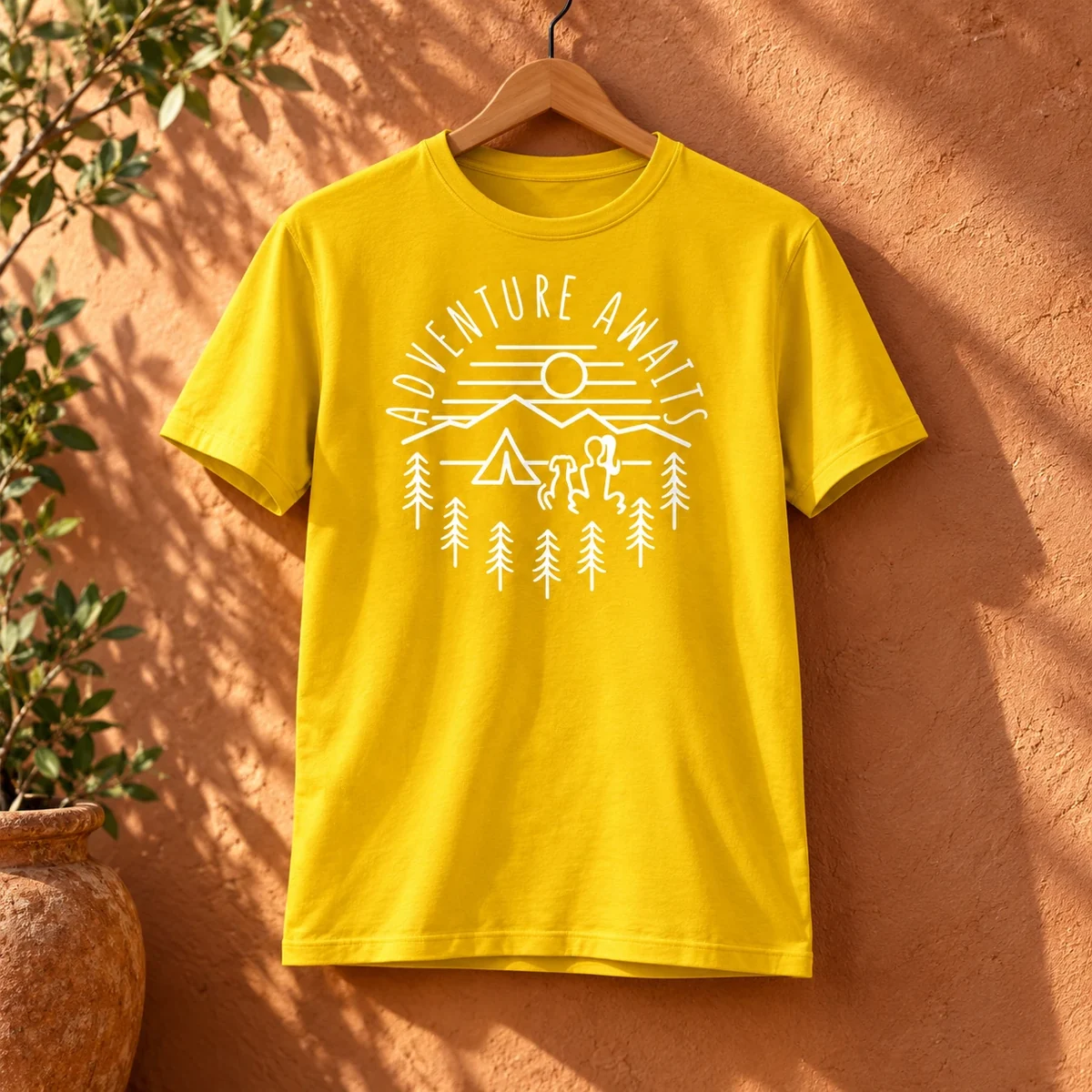 Adventure Awaits artwork printed on a realistically styled cotton T-shirt